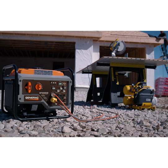 Portable generator being used to power circular saw for construction